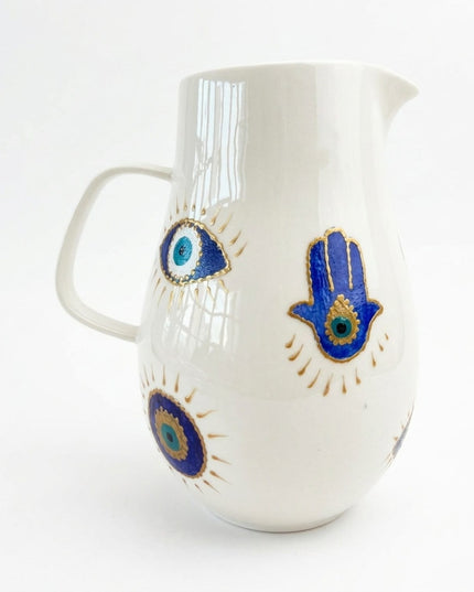 Karima hand-painted evil eye and hamsa glass water jug in shades of blue from Jordan