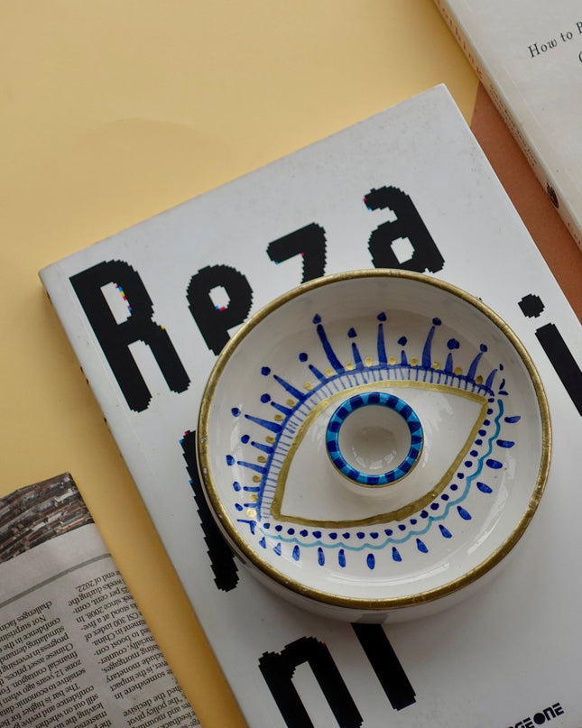Hand-Painted Evil Eye Palo Santo Holder on books