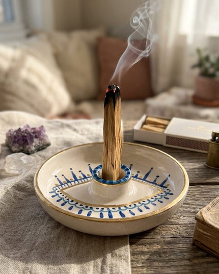Shanti Palo Santo Holder with a burning palo santo stick on a styled table