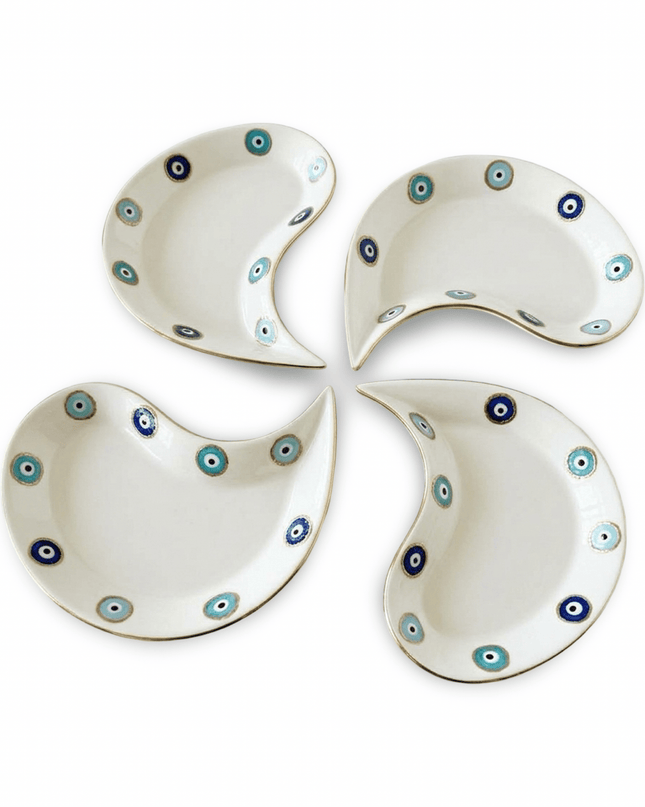 Hilal crescent porcelain dessert plates with evil eye design styled on a table with sweets