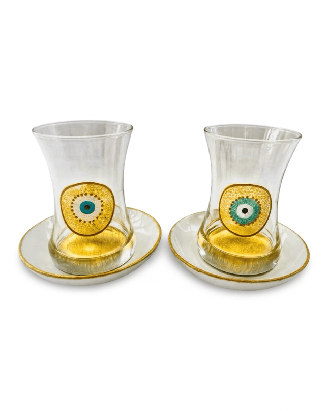 Two hand-painted evil eye tea glasses with gold-rimmed saucers from the Amina Teacups set