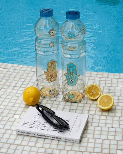 Hand-Painted Evil Eye Hamsa Water Bottles on a tiled background