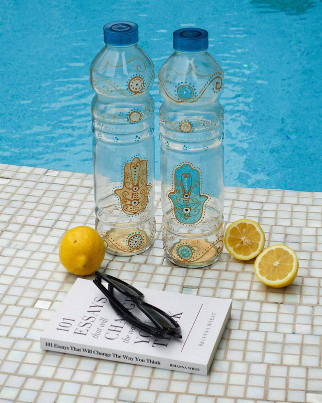 Hand-Painted Evil Eye Hamsa Water Bottles on a tiled background