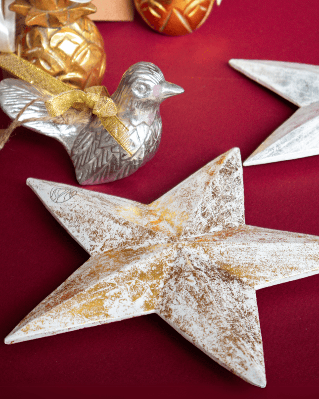 Decorative Christmas ornaments including stars, pineapple and a bird on a red background
