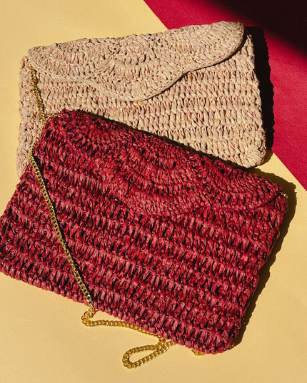 Two woven raffia handbags, one red and one beige, on a yellow and red background.