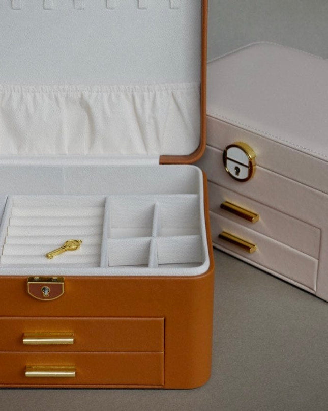 Jewelry box with open lid showing compartments on a gray background