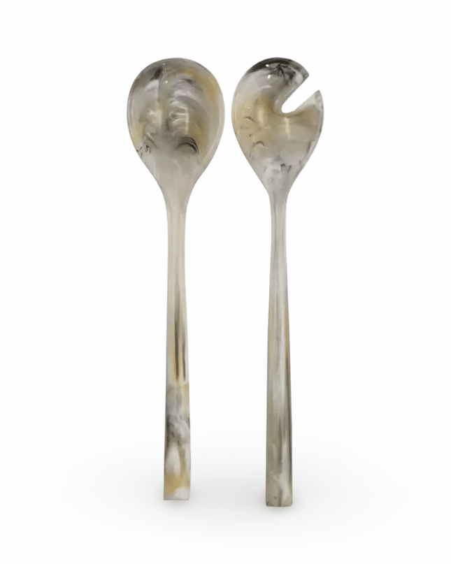 Two gray resin salad servers on a white background