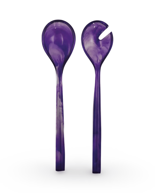 Two purple resin salad servers on a white background