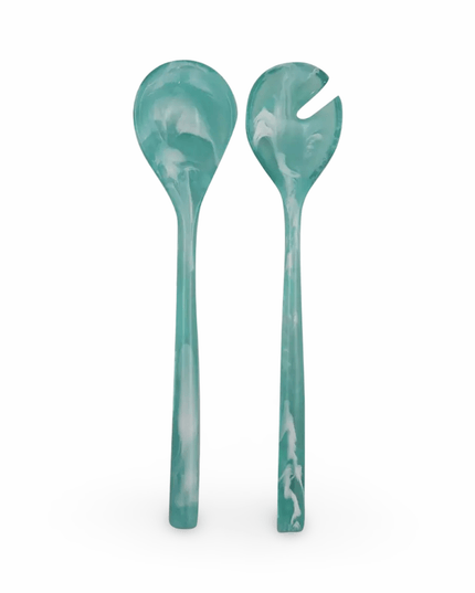 Two turquoise resin salad servers on a white background