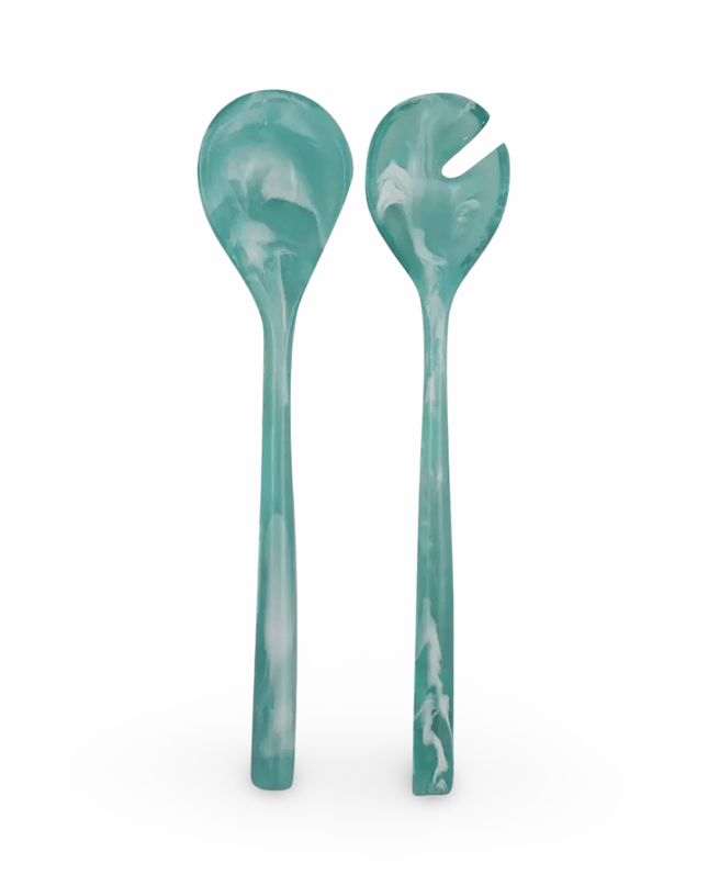 Two turquoise resin salad servers on a white background