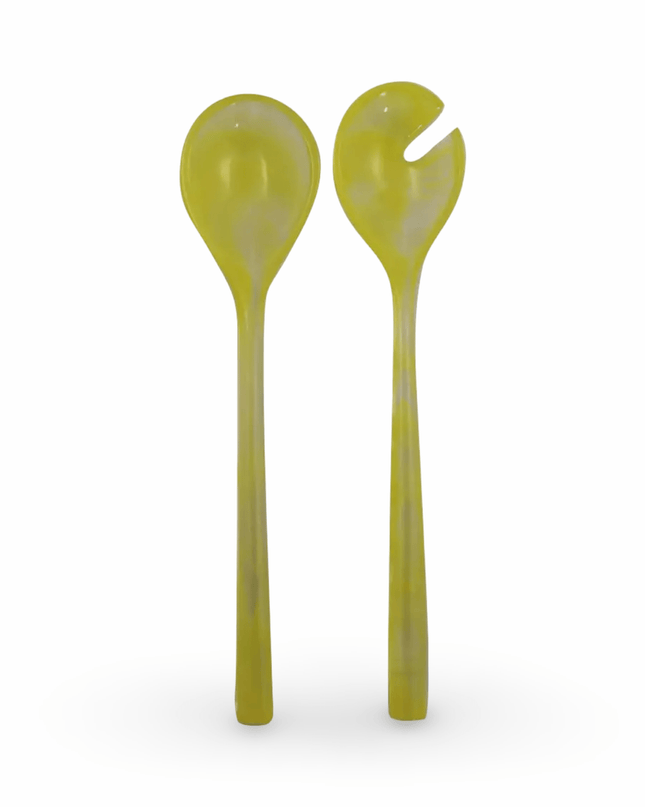 Two yellow resin salad servers on a white background