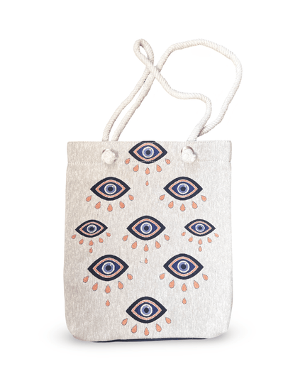 Canvas tote bag with evil eye pattern on a white background