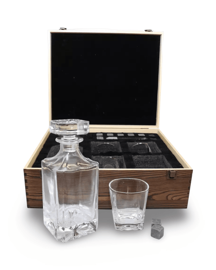 Glass decanter set with glasses and ice cubes in a wooden box on a white background