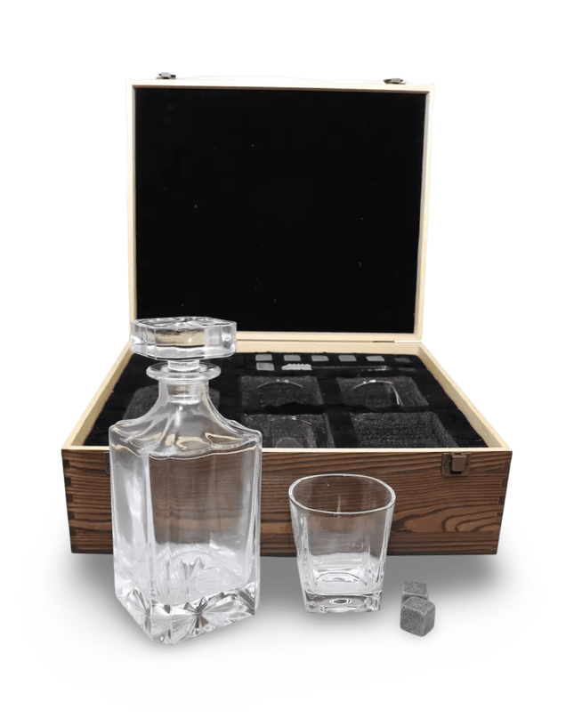 Glass decanter set with glasses and ice cubes in a wooden box on a white background