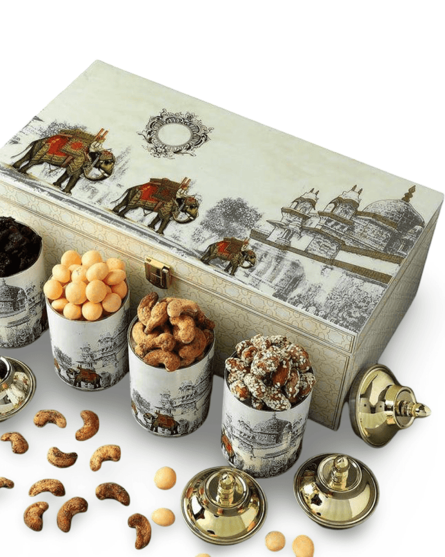 Decorative box with illustrations of elephants and architectural elements, surrounded by small containers of snacks on a white background.