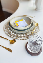 Load image into Gallery viewer, Nadia Dafri White Cotton Embroidery Yellow Napkin Beaded Placemat with Shells Gold Rustic Dinner Plate Gold Cutlery Whiskey Glass
