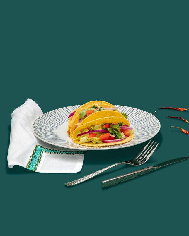 Chameli Hammered Silver Cutlery on White Striped Dinner Plate with Turquoise Embroidered Napkin Table Setting