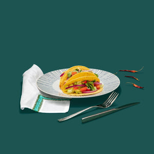 Chameli Hammered Silver Cutlery on White Striped Dinner Plate with Turquoise Embroidered Napkin Table Setting
